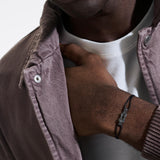 Model Wearing John Hardy Mens Rhodium Manah Knot Extra Thin Width Black Cord Bracelet