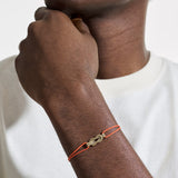 Model Wearing John Hardy Mens 14k Gold Manah Knot Thin Width Orange Cord Bracelet