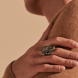 Model Wearing John Hardy Mens Legends Naga Dragon Ring in Volcanic Texture Silver with Blue Sapphires